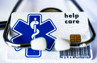 A card with a stethoscope attached to it by Marek Studzinski courtesy of Unsplash.