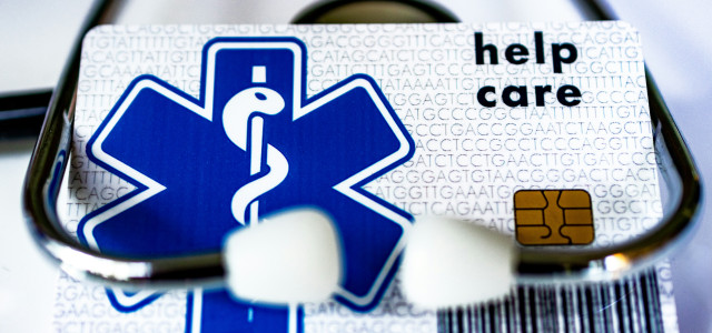 A card with a stethoscope attached to it by Marek Studzinski courtesy of Unsplash.