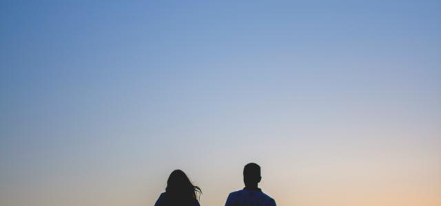 man and woman holding hands in silhouette photography by Caleb Ekeroth courtesy of Unsplash.